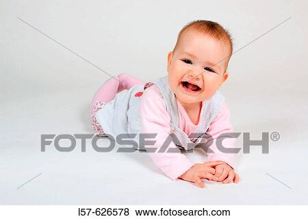 Baby lying on tummy, smiling View Large Photo Image Stock Photo - Baby lying on tummy, smiling. Fotosearch