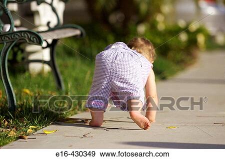 Baby moving down the sidewalk View Large Photo Image Stock Photo - Baby moving down the sidewalk. Fotosearch