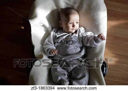 Baby on a bouncy chair View Large Photo Image Picture - Baby on a bouncy chair. Fotosearch