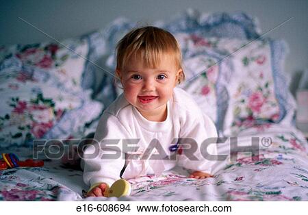 Picture - Baby on parent's bed. Fotosearch