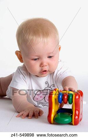 Baby playing with a toy. View Large Photo Image Stock Photo - Baby playing with a toy.. Fotosearch