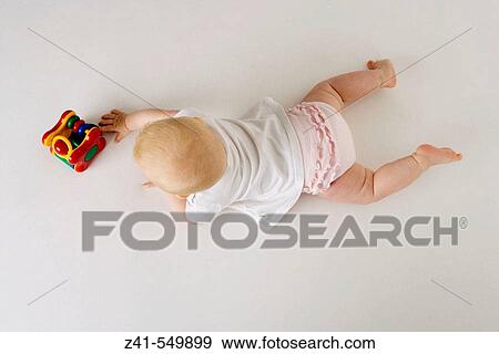 Stock Photo - Baby playing with a toy.. Fotosearch