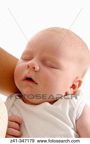 Stock Photo - Baby resting on mum's arms. Fotosearch