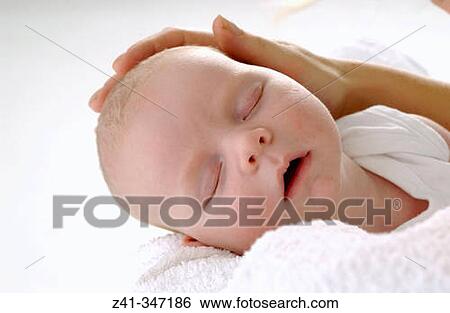 Baby resting on mum's arms View Large Photo Image Stock Photograph - Baby resting on mum's arms. Fotosearch