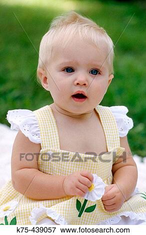 Stock Photo - baby sitting on lawn. Fotosearch