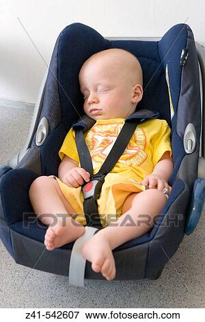 Baby sleeping in a maxicosy. View Large Photo Image Stock Photo - Baby sleeping in a maxicosy.. Fotosearch