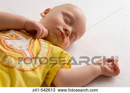 Baby sleeping on the floor. View Large Photo Image Stock Image - Baby sleeping on the floor.. Fotosearch
