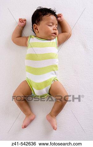 Baby sleeping on the floor. View Large Photo Image Stock Photograph - Baby sleeping on the floor.. Fotosearch