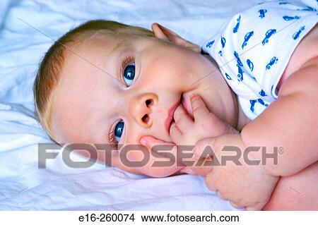 Picture - baby sucking fingers. Fotosearch
