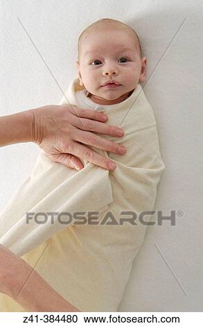 Stock Image - Baby swaddled. Fotosearch