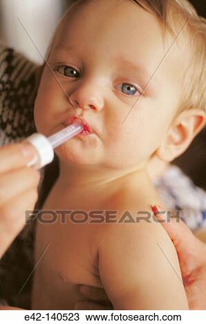 Baby taking medicine View Large Photo Image Stock Image - Baby taking medicine. Fotosearch