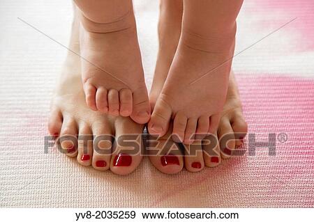 Baby toes on her mother's feet. View Large Photo Image Stock Photo - Baby toes on her mother's feet.. Fotosearch