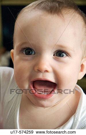 Baby with a happy expression. View Large Photo Image Stock Photo - Baby with a happy expression.. Fotosearch