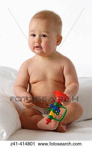 Baby with a toy View Large Photo Image Stock Image - Baby with a toy. Fotosearch