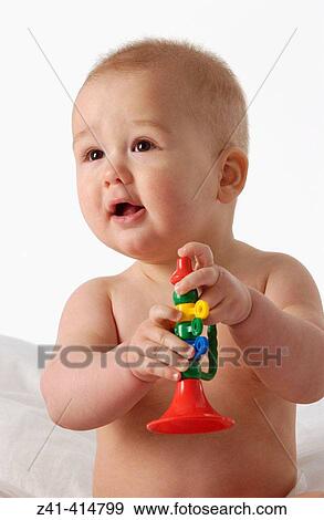 Stock Photo - Baby with a toy. Fotosearch