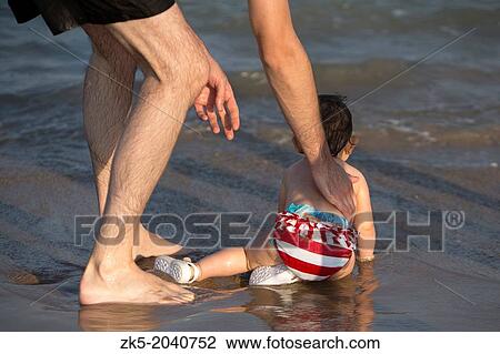 Baby with her father on a beach day. Pinedo, Valencia. View Large Photo Image Stock Image - Baby with her father on a beach day. Pinedo, Valencia.. Fotosearch