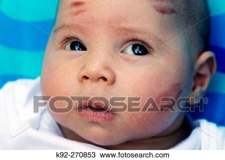 Baby with kisses on his face View Large Photo Image Stock Image - Baby with kisses on his face. Fotosearch