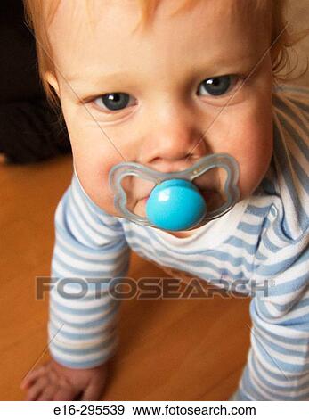 Stock Photo - baby with pacifier. Fotosearch