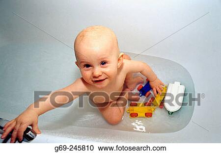 Stock Image - Babygirl in the bath. Medle. Vasterbotten. Sweden. Fotosearch