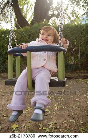 babygirl, One year, Toddler, Outdoors, Garden, Playground, Swing, Almond Tree, Autumn, Toothless, tooth View Large Photo Image Stock Image - babygirl, One year, Toddler, Outdoors, Garden, Playground, Swing, Almond Tree, Autumn, Toothless, tooth. Fotosearch