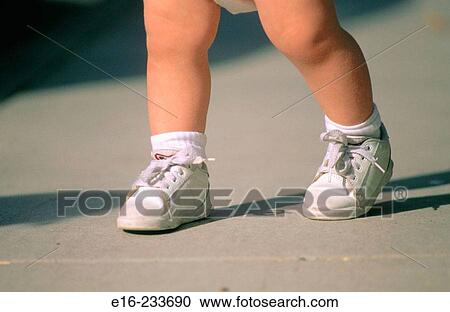 Stock Image - Baby's legs and shoes. Fotosearch