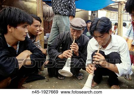 Stock Photo - Bac Ha; Mountain Village; Sunday Market; local People playing Trumpet; Vietnam.. Fotosearch