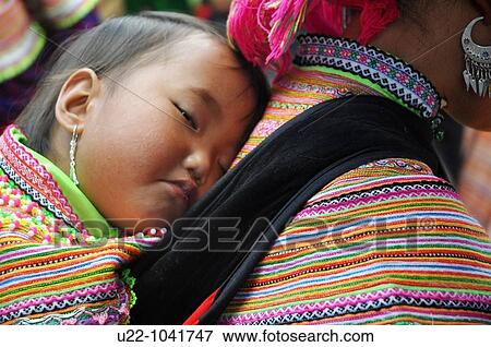Bac Ha (Vietnam): a Hmong baby sleeping on the mother's back at the Sunday morning market View Large Photo Image Stock Photo - Bac Ha (Vietnam): a Hmong baby sleeping on the mother's back at the Sunday morning market. Fotosearch
