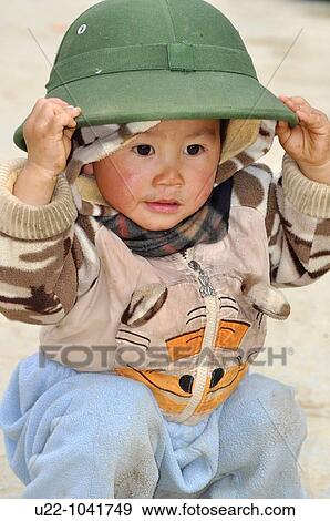 Bac Ha (Vietnam): child with the n? n coi traditional Vietnamese hat View Large Photo Image Stock Photo - Bac Ha (Vietnam): child with the n? n coi traditional Vietnamese hat. Fotosearch