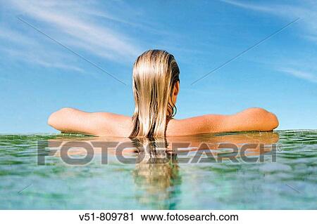 Back view of a woman in a pool View Large Photo Image Stock Image - Back view of a woman in a pool. Fotosearch