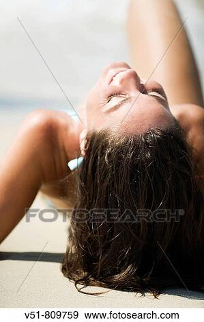Back view of a woman laying by the sea View Large Photo Image Stock Photo - Back view of a woman laying by the sea. Fotosearch