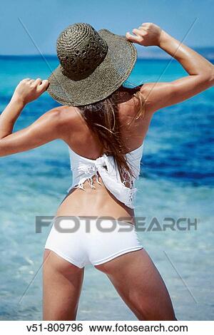 Back view of a woman with a hat by the sea View Large Photo Image Stock Photograph - Back view of a woman with a hat by the sea. Fotosearch