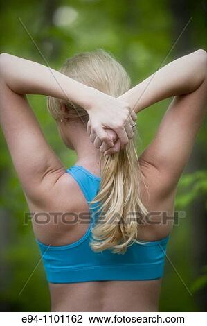 Back view of a young blond woman stretching arms behind her head. View Large Photo Image Stock Image - Back view of a young blond woman stretching arms behind her head.. Fotosearch