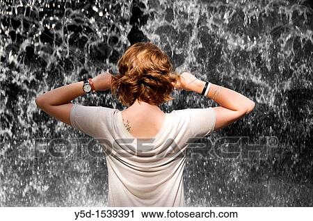 back view of exhauted young woman standing in front of noisy falling water View Large Photo Image Stock Image - back view of exhauted young woman standing in front of noisy falling water. Fotosearch