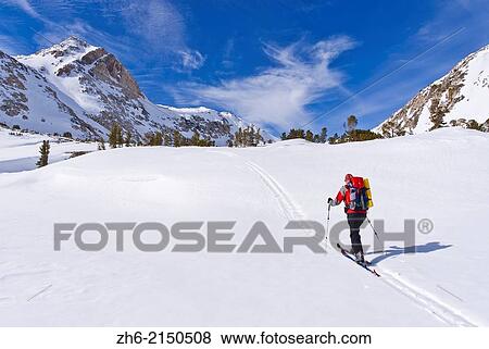 Backcountry skier under Piute Pass, Inyo National Forest, Sierra Nevada Mountains, California USA. View Large Photo Image Stock Photo - Backcountry skier under Piute Pass, Inyo National Forest, Sierra Nevada Mountains, California USA.. Fotosearch