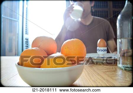 Backlight. Man sitting near table, drinking a glass of milk for lunch. View Large Photo Image Stock Image - Backlight. Man sitting near table, drinking a glass of milk for lunch.. Fotosearch
