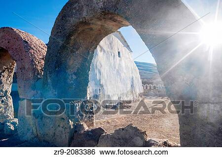 Backlit shot with sun star of limestone arch fence surrounding the remote church San Juan Bautista on edge of salt flats, Salar de Uyuni, Bolivia, South America. View Large Photo Image Stock Photograph - Backlit shot with sun star of limestone arch fence surrounding the remote church San Juan Bautista on edge of salt flats, Salar de Uyuni, Bolivia, South America.. Fotosearch