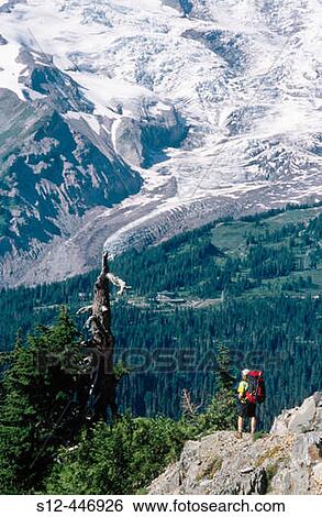Stock Photograph - Backpacker and Mt. Rainier. Mt. Rainier National Park. Washington. USA.. Fotosearch