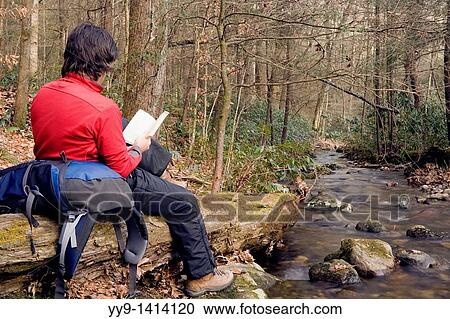Backpacker reading by creek - Daniel Ridge - Pisgah National Forest - near Brevard, North Carolina, USA View Large Photo Image Stock Image - Backpacker reading by creek - Daniel Ridge - Pisgah National Forest - near Brevard, North Carolina, USA. Fotosearch