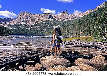 Stock Image - backpacking at Hell Roaring Lake with The Finger Of Fate and The Arrowhead above high on the Sawtooth Crest in the Sawtooth Mountains in central Idaho.. Fotosearch