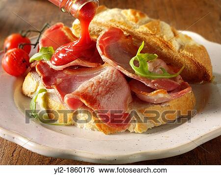 Bacon sandwich with tomato ketchup View Large Photo Image Stock Photograph - Bacon sandwich with tomato ketchup. Fotosearch