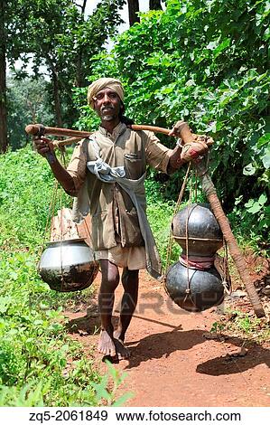 Stock Photo - Baiga man brewing mahua Liquor. Baiga Tribe, Chada village, Madhya Pradesh, India.. Fotosearch