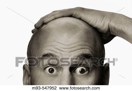 Stock Image - Bald caucasian man, 40-ish, with hand on top of head. Surprised look. Sepia. Fotosearch
