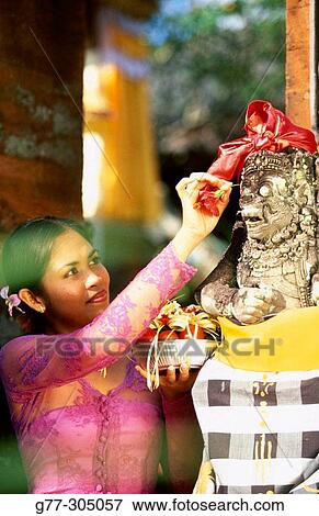 Balinese woman making offering to gods, Indonesia View Large Photo Image Stock Photo - Balinese woman making offering to gods, Indonesia. Fotosearch