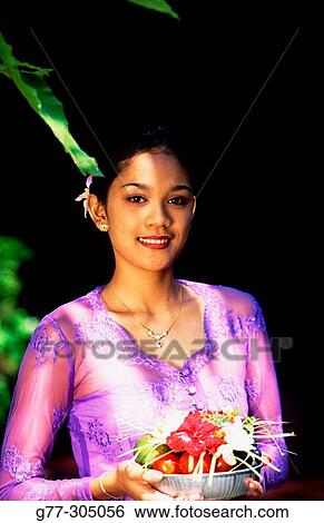 Balinese woman making offering to gods. Ubud, Indonesia View Large Photo Image Stock Photograph - Balinese woman making offering to gods. Ubud, Indonesia. Fotosearch