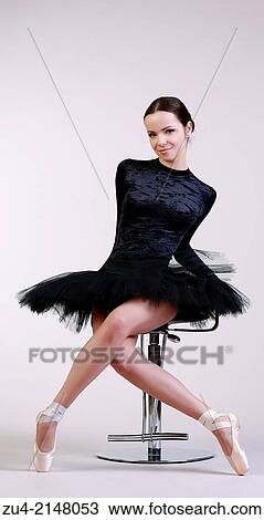 Stock Image - Ballerina posing in black tutu. Fotosearch