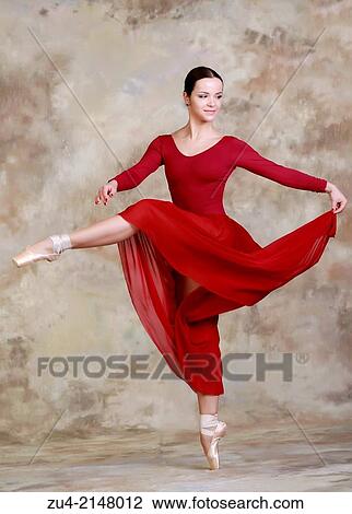 Stock Image - Ballerina posing in red dress. Fotosearch