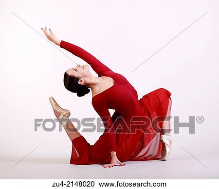 Stock Image - Ballerina posing in red dress. Fotosearch