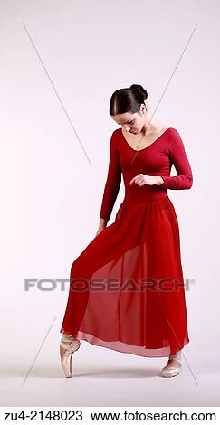 Stock Image - Ballerina posing in red dress. Fotosearch