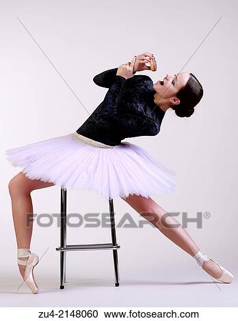 Stock Image - Ballerina posing with food. Fotosearch