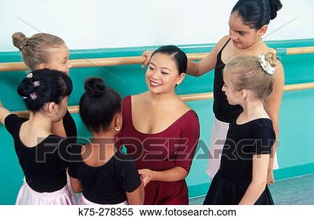 Ballet teacher caring for her students View Large Photo Image Stock Photography - Ballet teacher caring for her students. Fotosearch